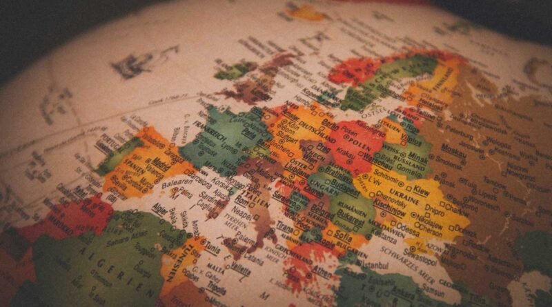 Close-up of a vintage globe focusing on Europe, with colored country regions and legible names.